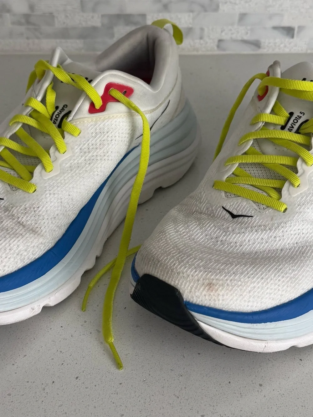 Hoka White Running Shoes with Neon Yellow Laces and Blue Accents